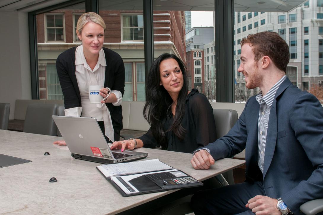 UMass graduates in a business setting